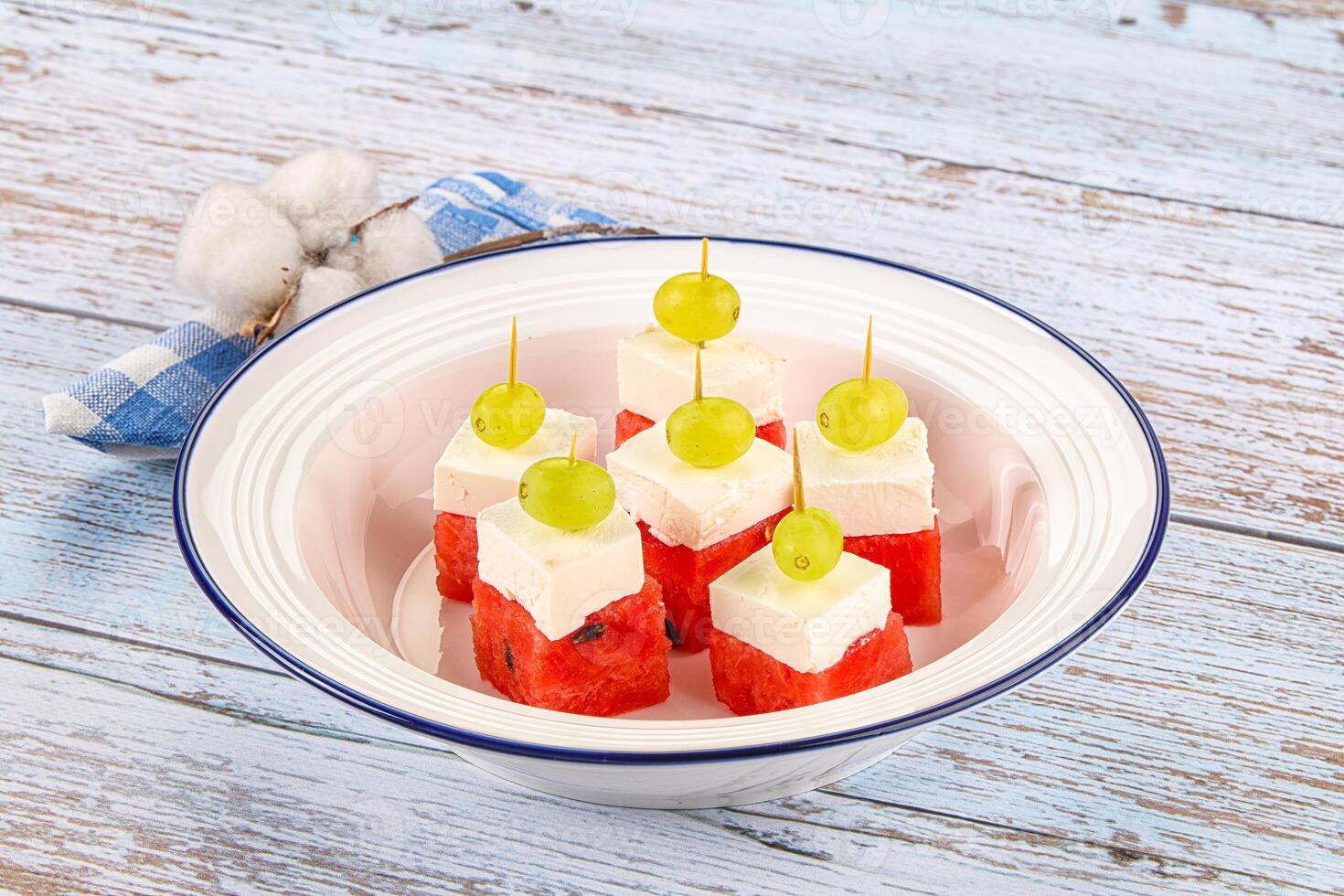 A bowl of watermelon and cheese photo