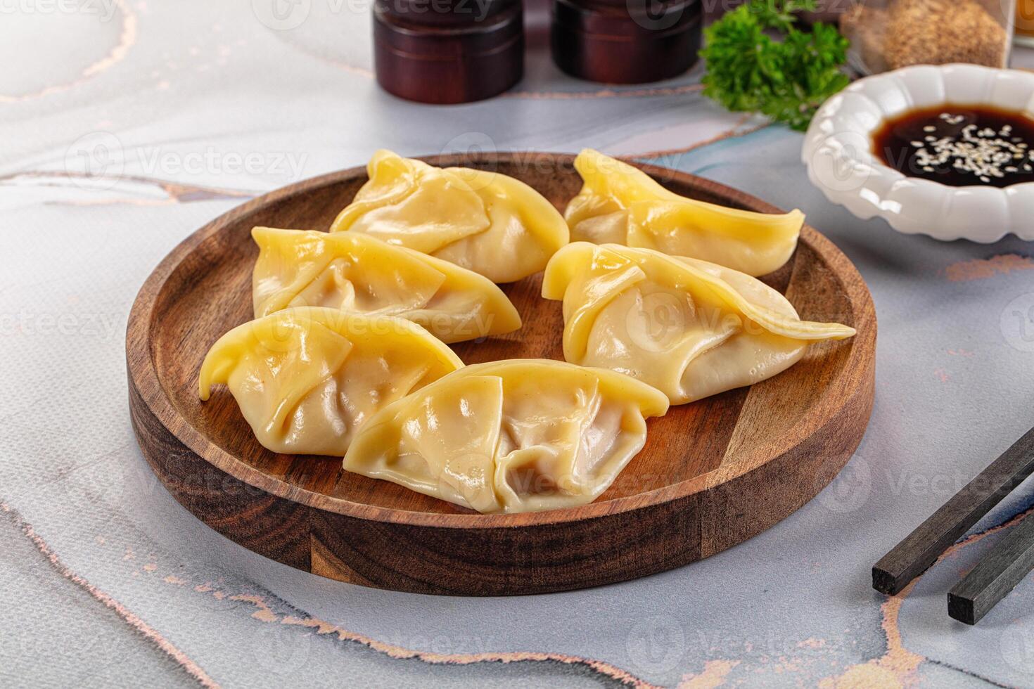 A plate with dumplings on it and some chopsticks photo