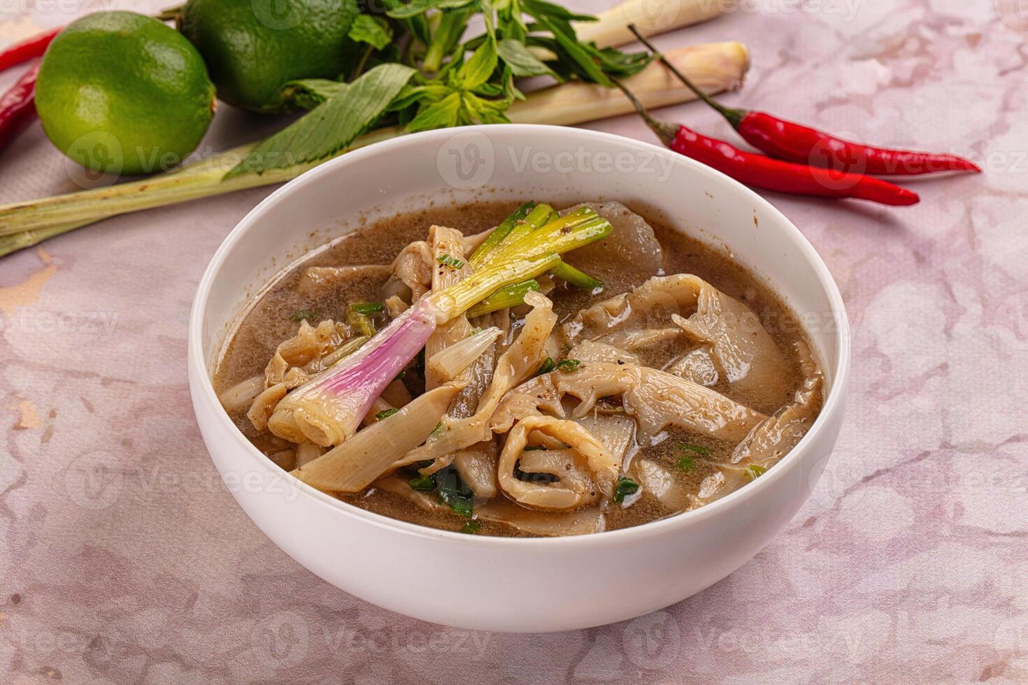 A bowl of soup with noodles and vegetables photo