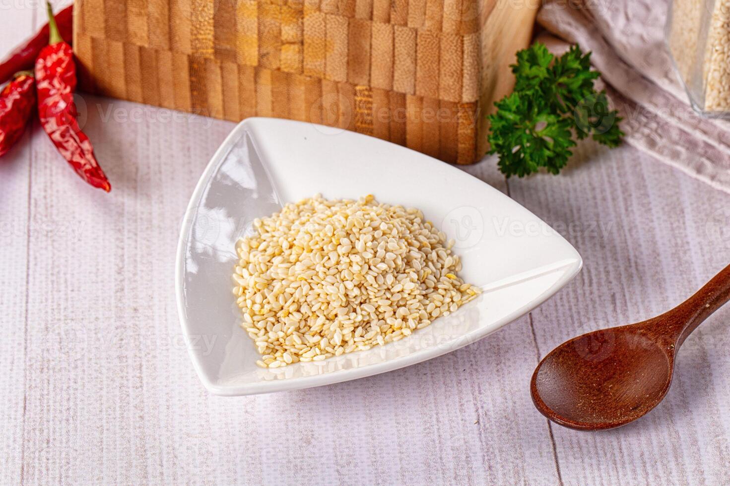 A bowl of rice and a wooden spoon on a table photo