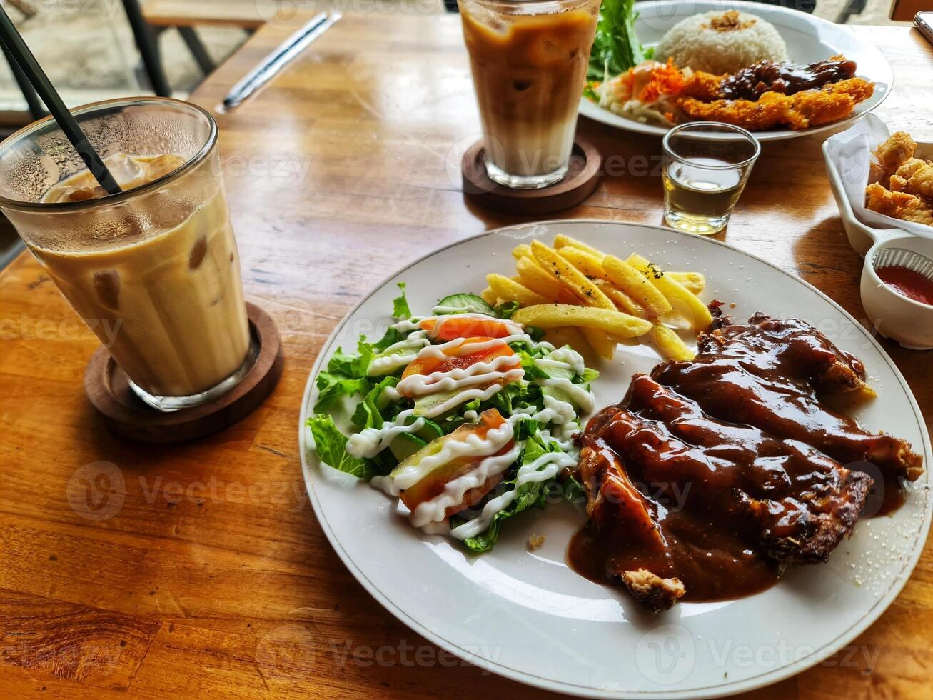 Enjoying Chicken Steak with Fries and Salad at Cafe photo