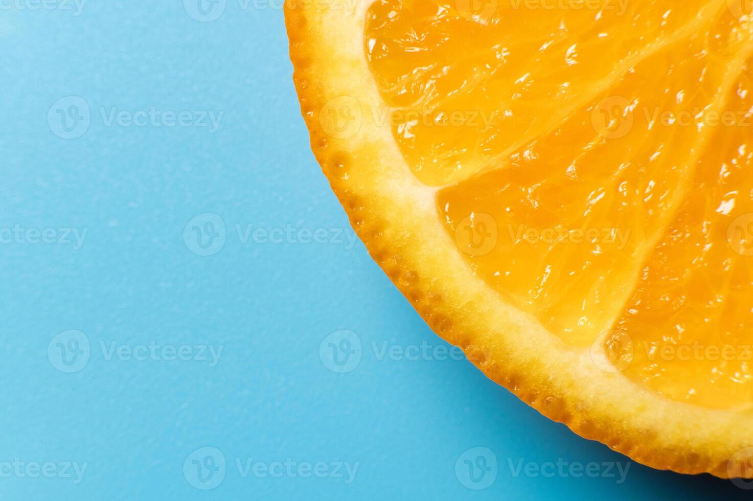 Orange slice, on a blue background. Top view. Flat lay, macro shot. Banner concept for advertising photo