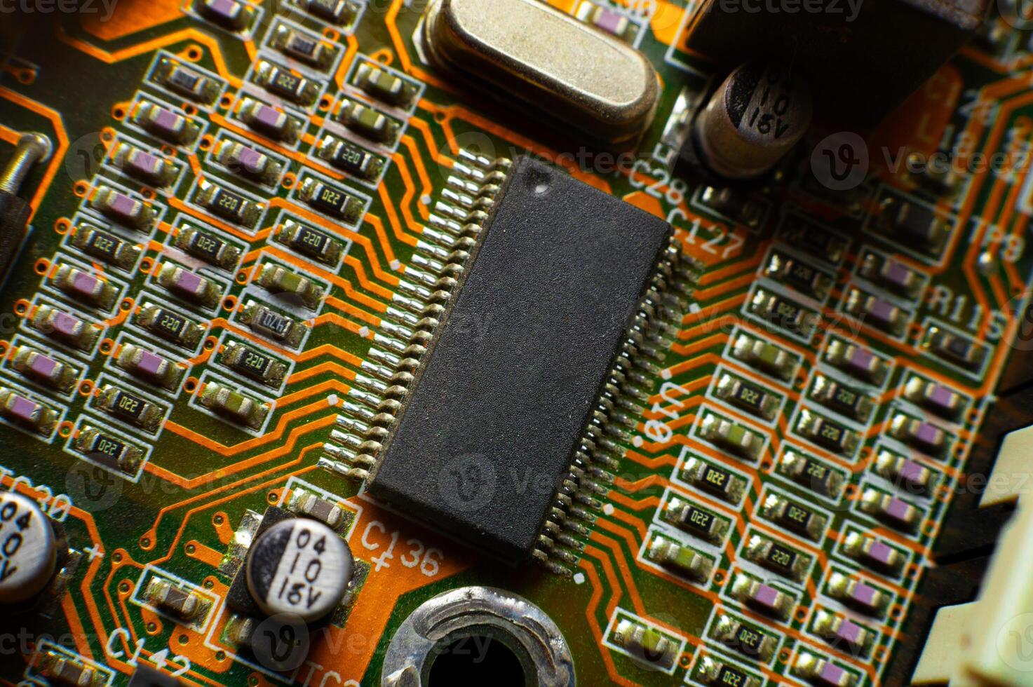 Elements of microcircuits on a green and red board. Microprocessor on the board. Old processor photo