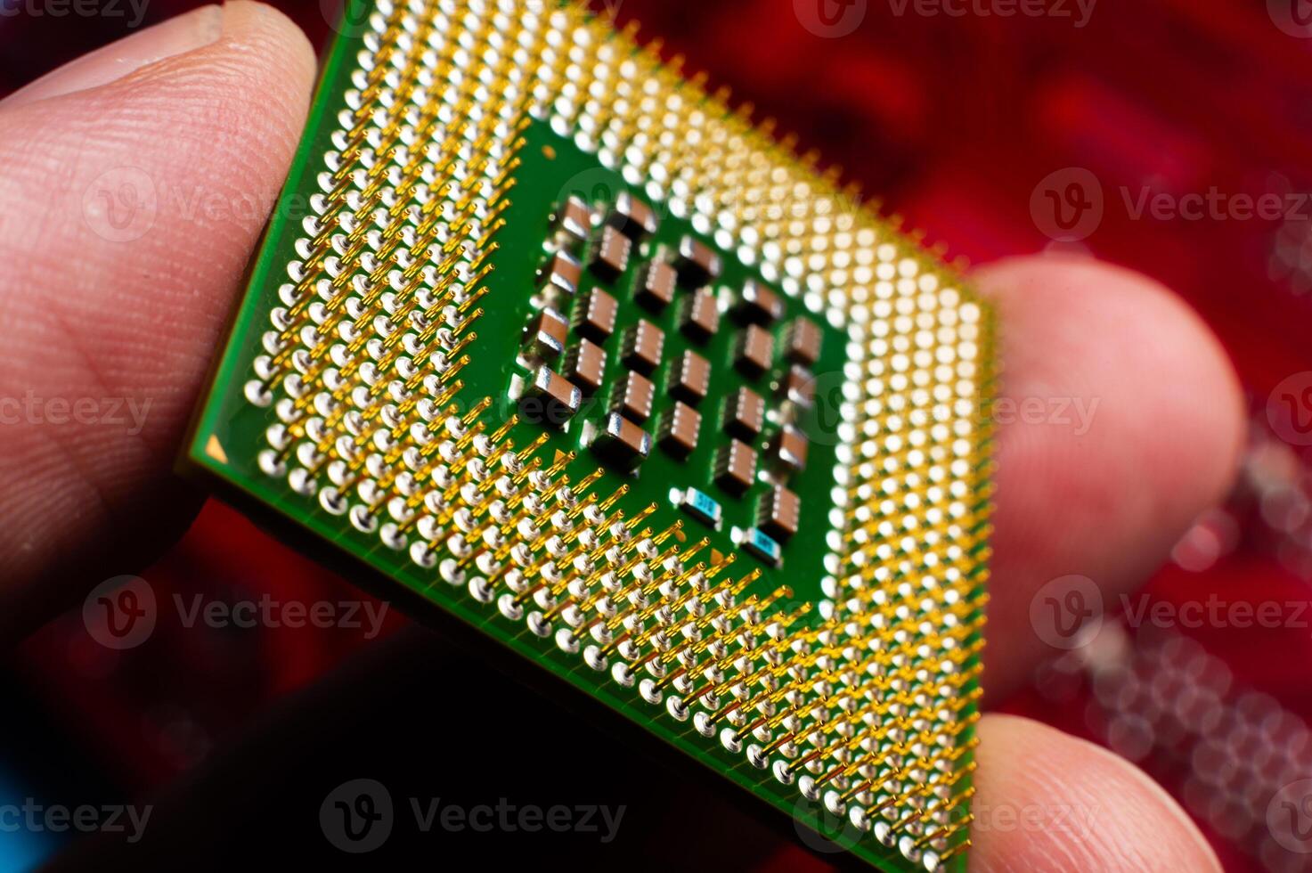 computer support engineer installs a processor. A microprocessor with the silicon core and cache chip clearly visible. Installing a computer processor into a socket photo