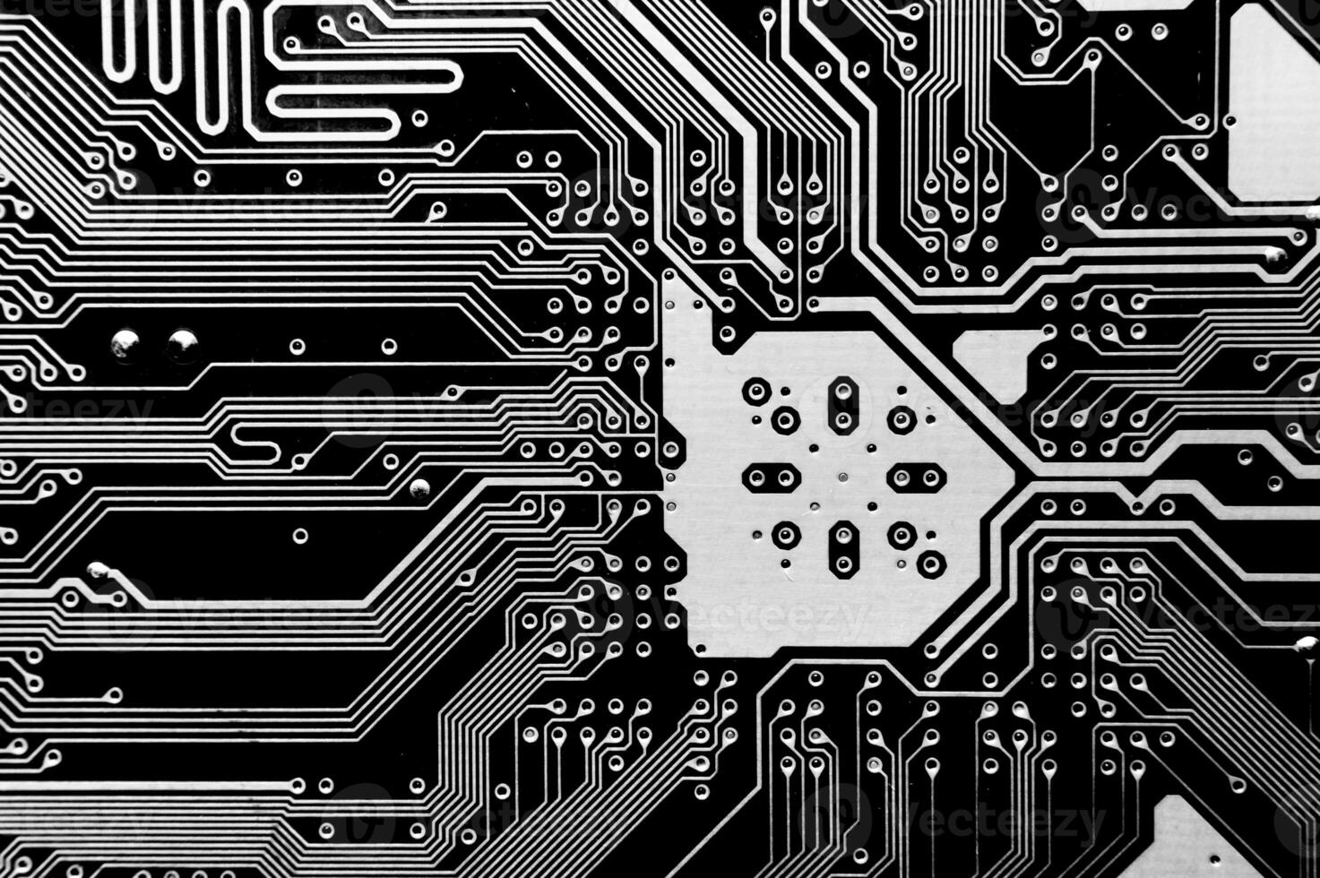 Close-up of a printed computer circuit board. Computer motherboard, macro shot. Abstract futuristic background photo