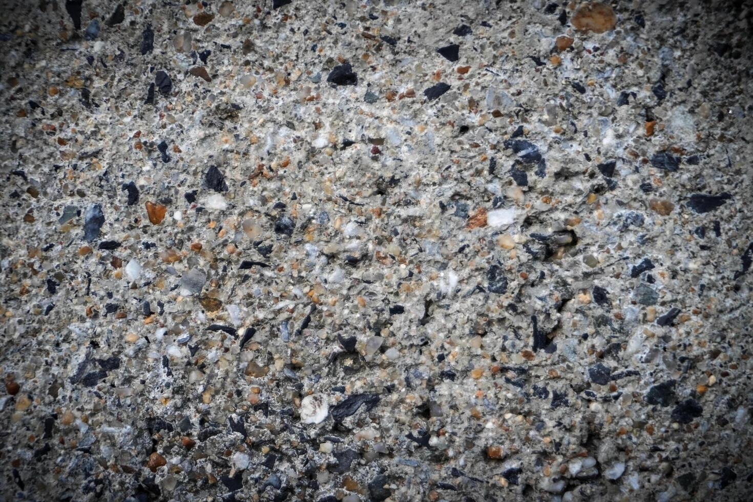 Background, Cement wall surface, damaged, revealed that many granite stones are components. photo