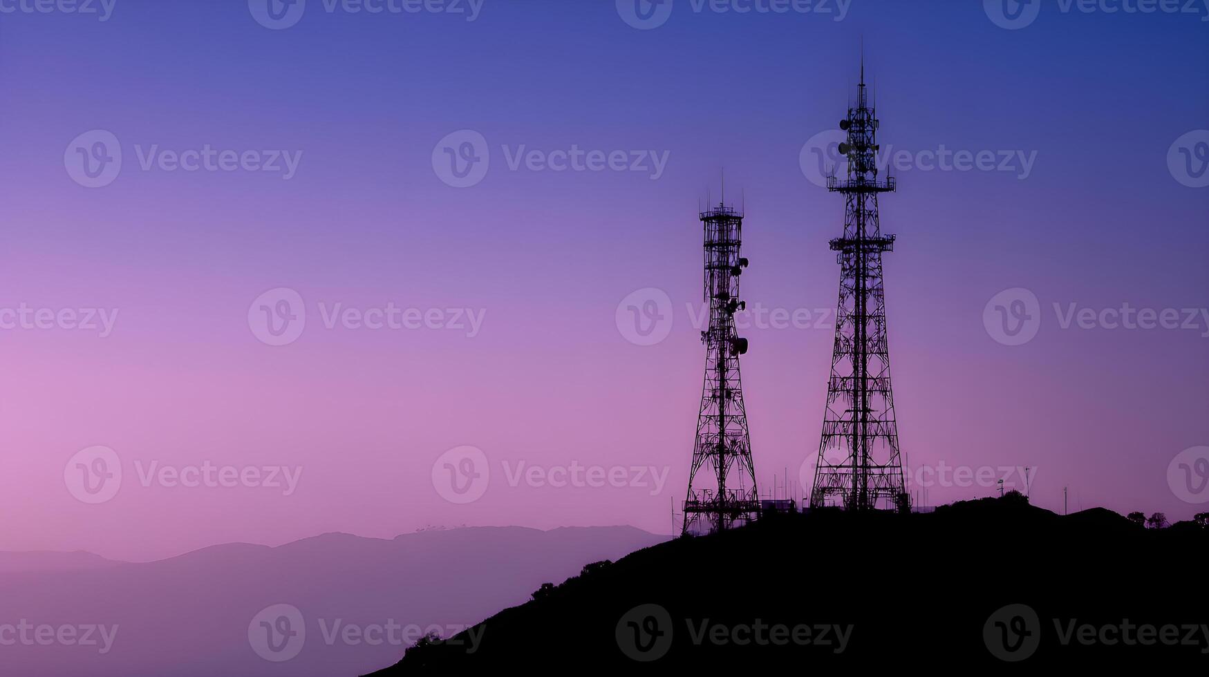 Telecommunication towers silhouetted against a purple sunset sky photo