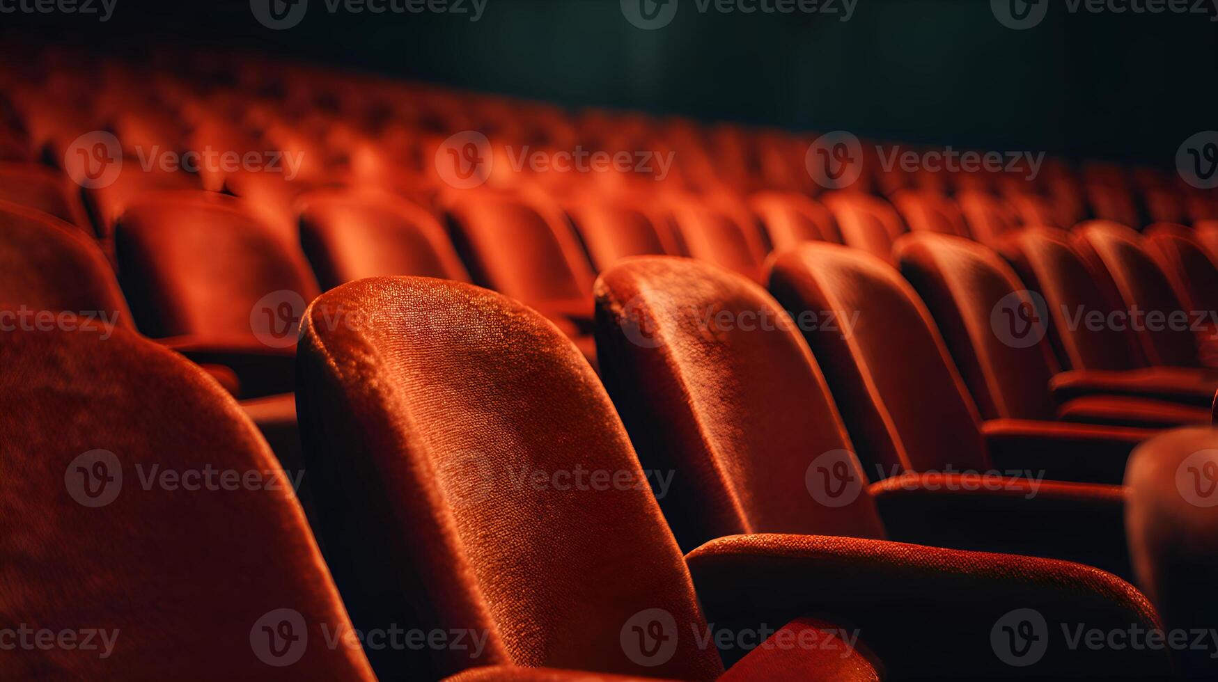 Empty red velvet seats creating lines in a theatre photo