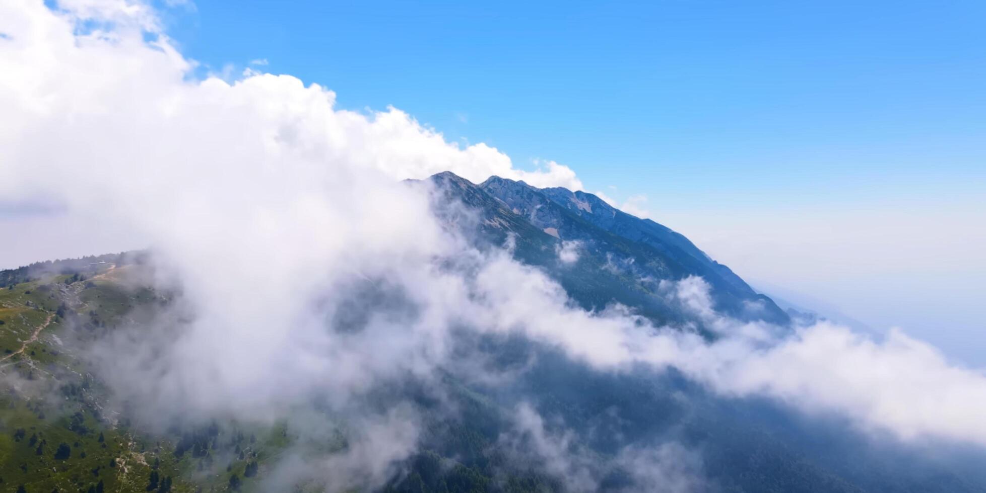 A view of the mountains from above with clouds photo