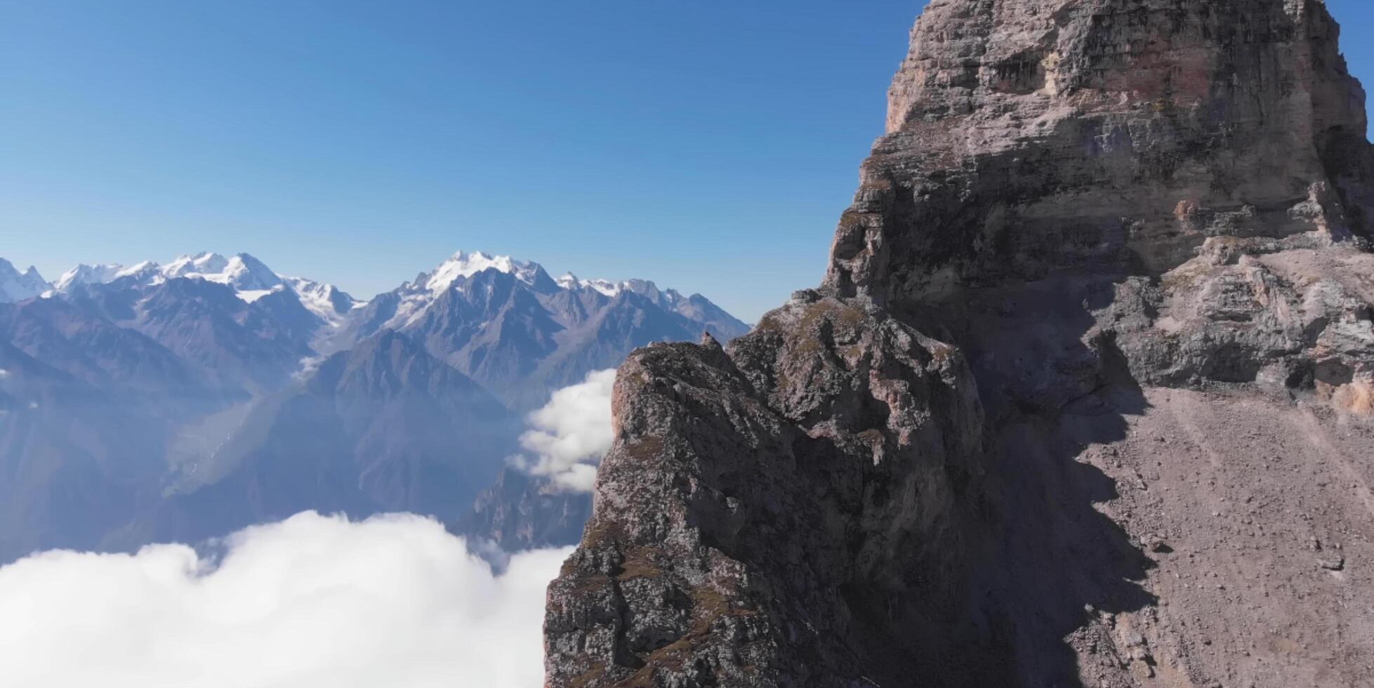 A mountain with a large rock on top photo