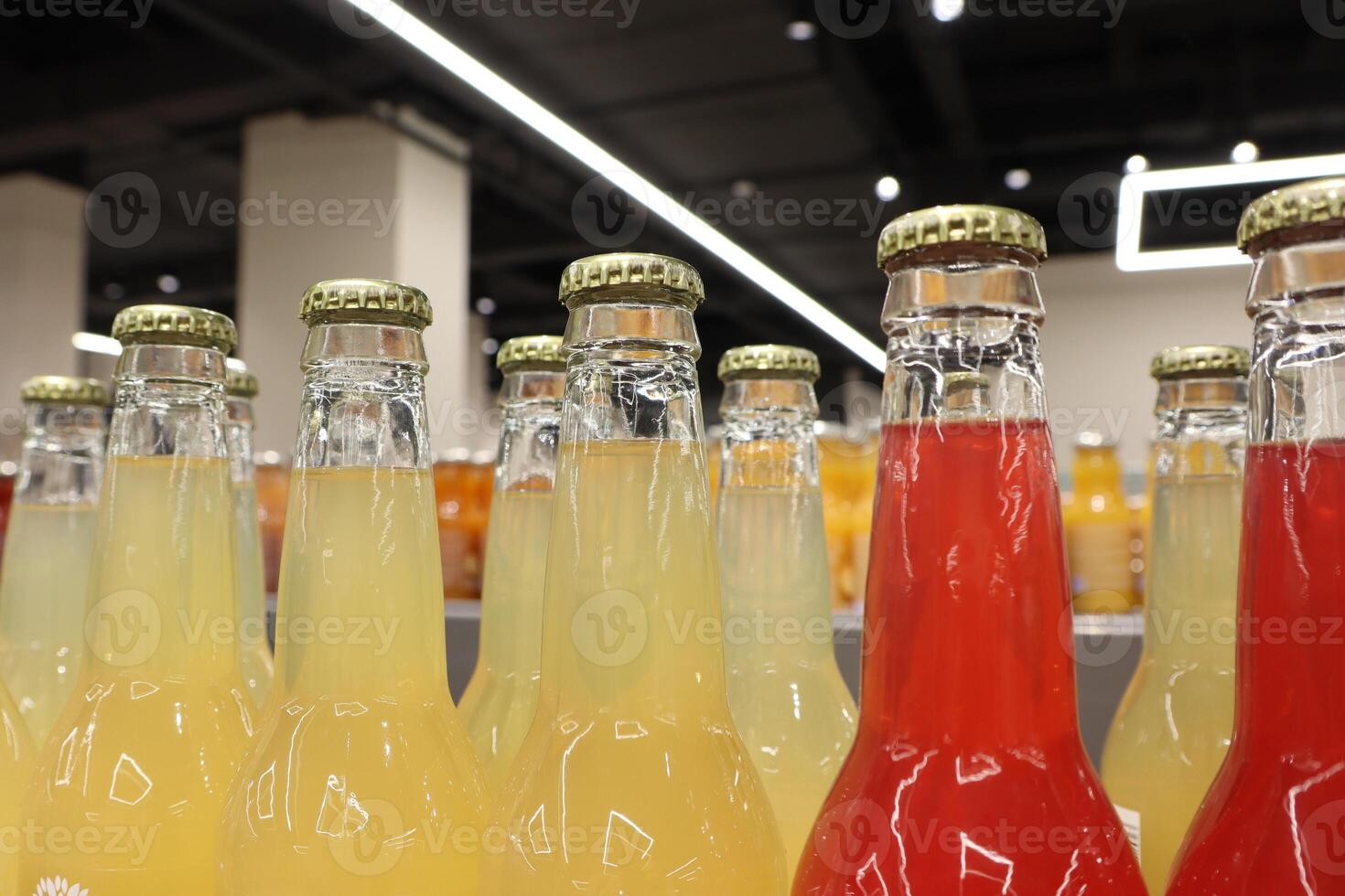An array of stunningly colorful bottled beverages beautifully showcased on display shelves photo