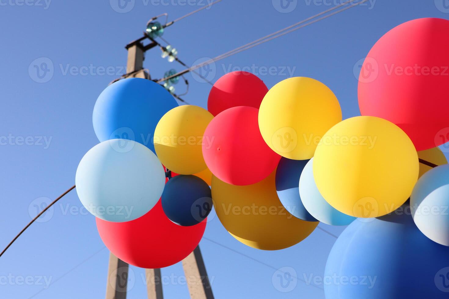 The Vibrant and Colorful Balloons Floating Against a Beautifully Bright Blue Sky photo