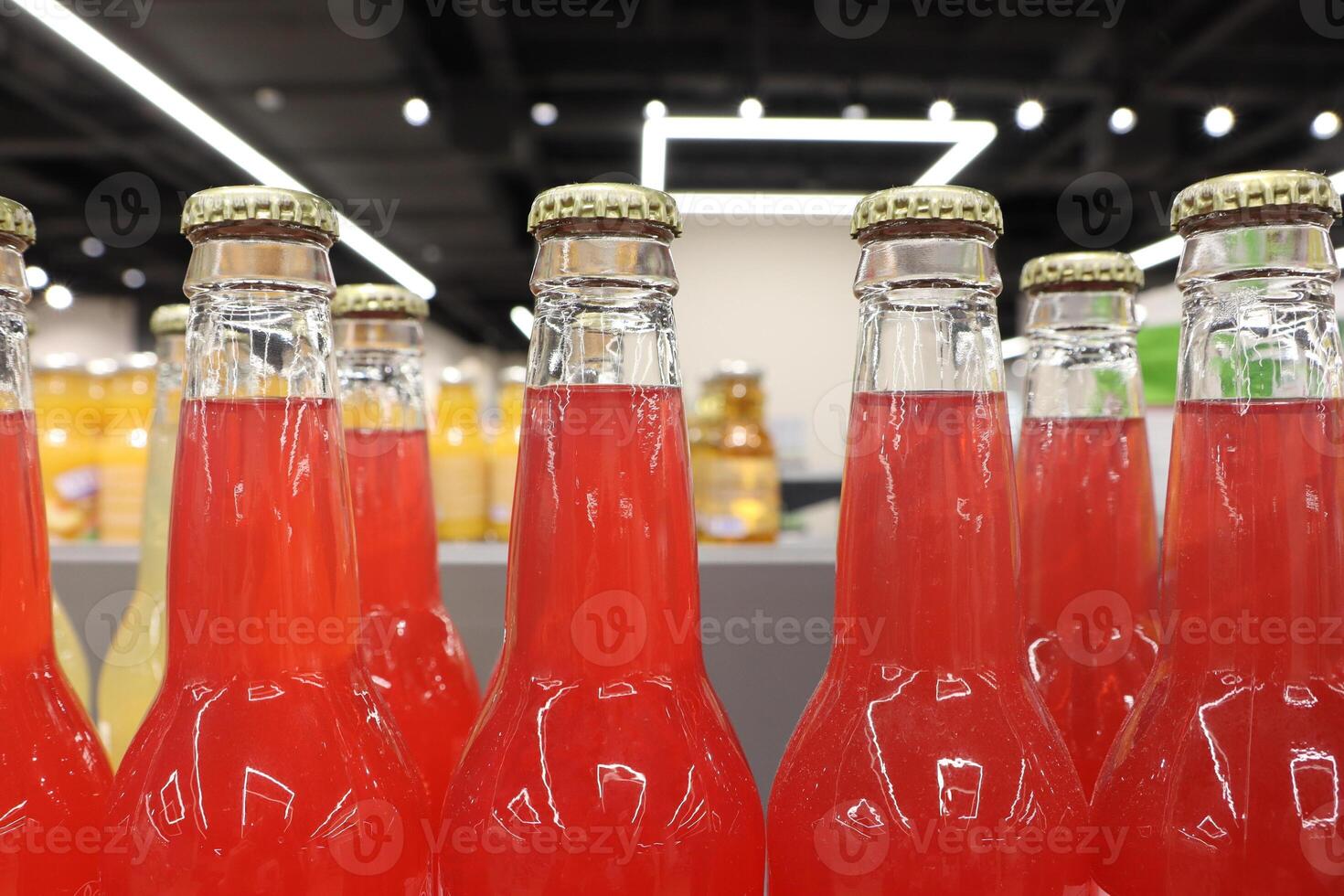 A Collection of Vibrantly Colored Bottles Filled with Refreshing Soft Drinks on Display photo