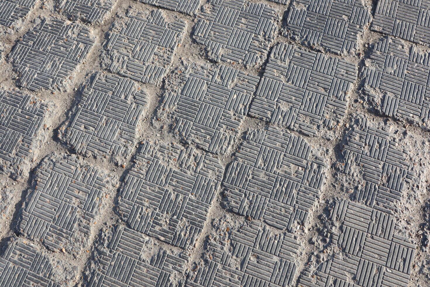 A closeup view of textured paving stones placed on a walkway or pathway surface photo