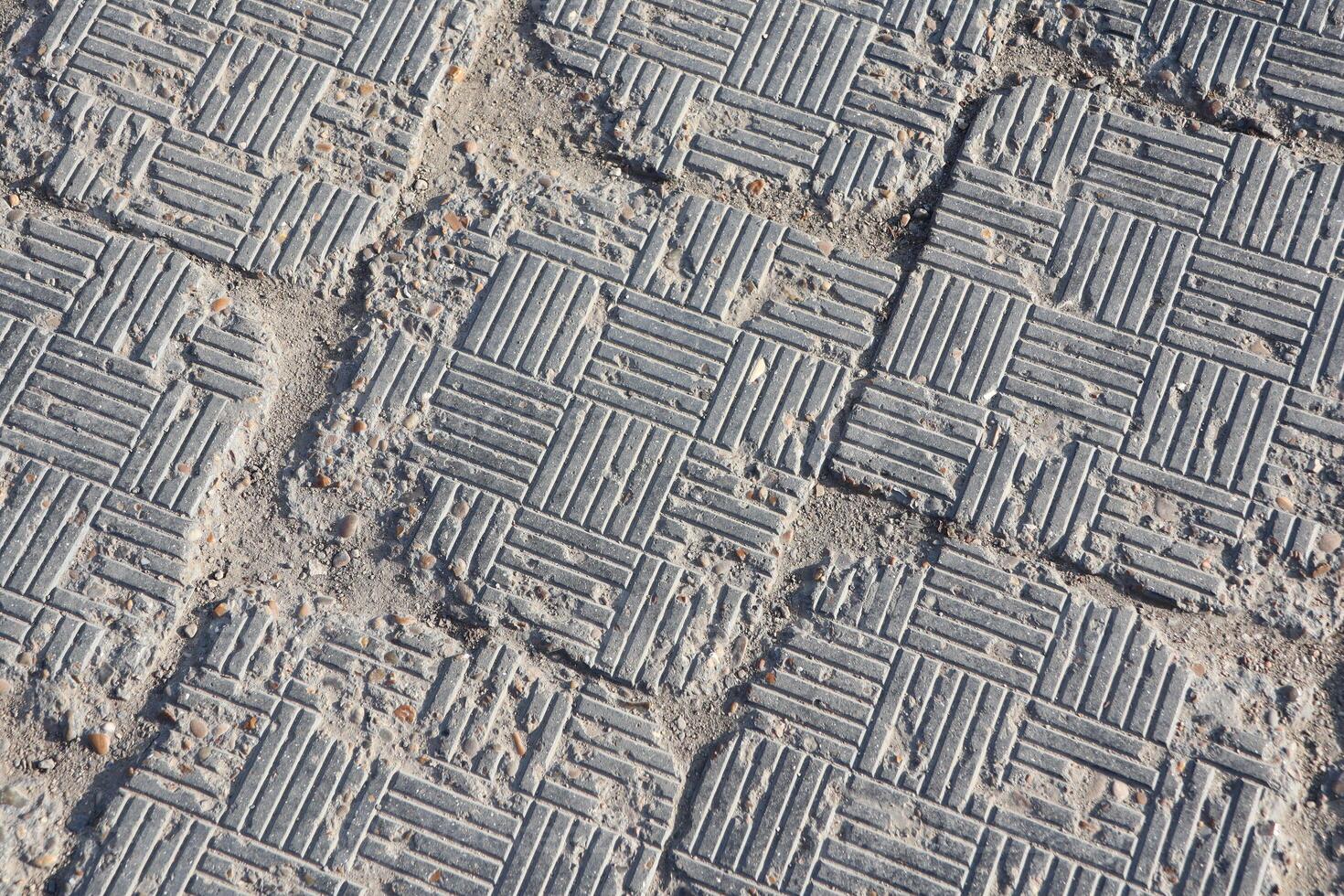 Textured Paving Stones Featuring a Grid Pattern Set Against an Urban Environment and Landscape photo