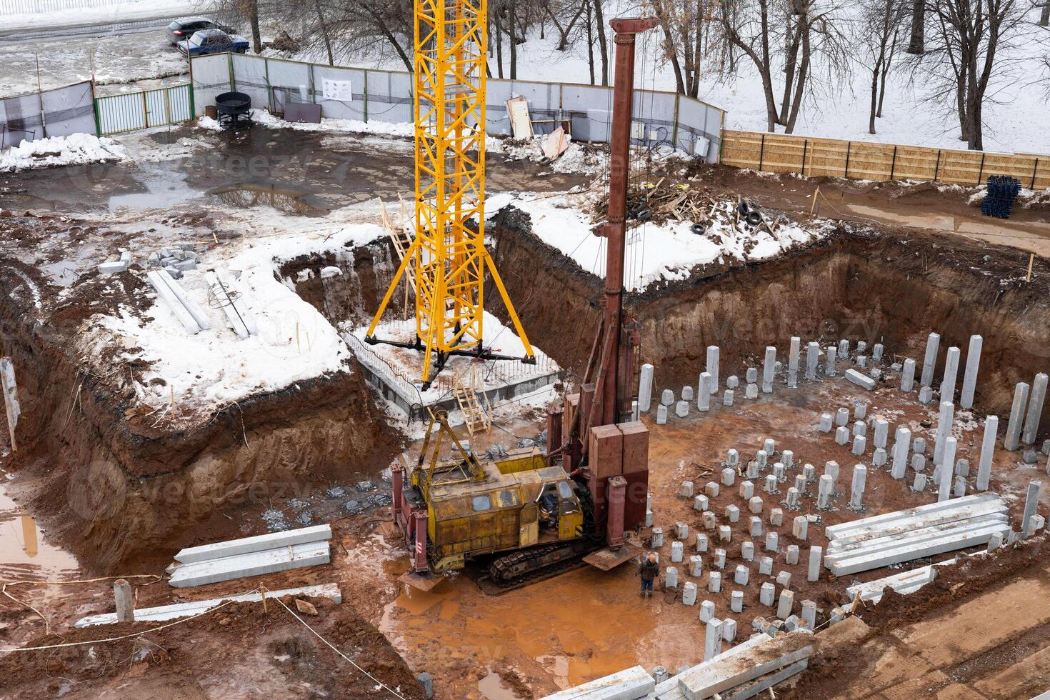 Construction of a residential building in the city, preparation of the foundation, work on an excavator photo