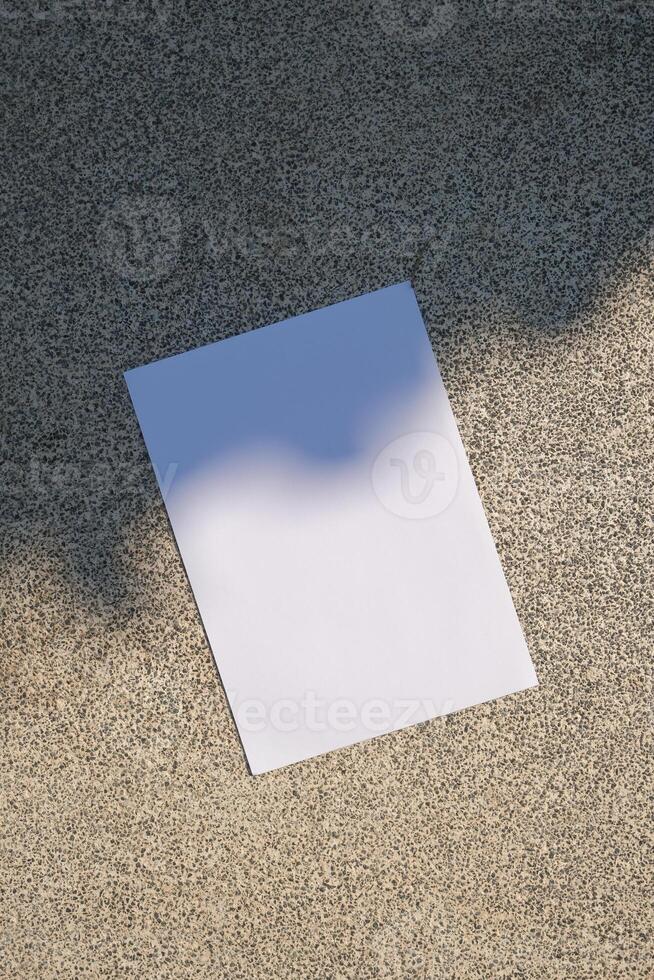 empty poster mockup on concrete stone floor or pavement outdoors, shadow overlay photo