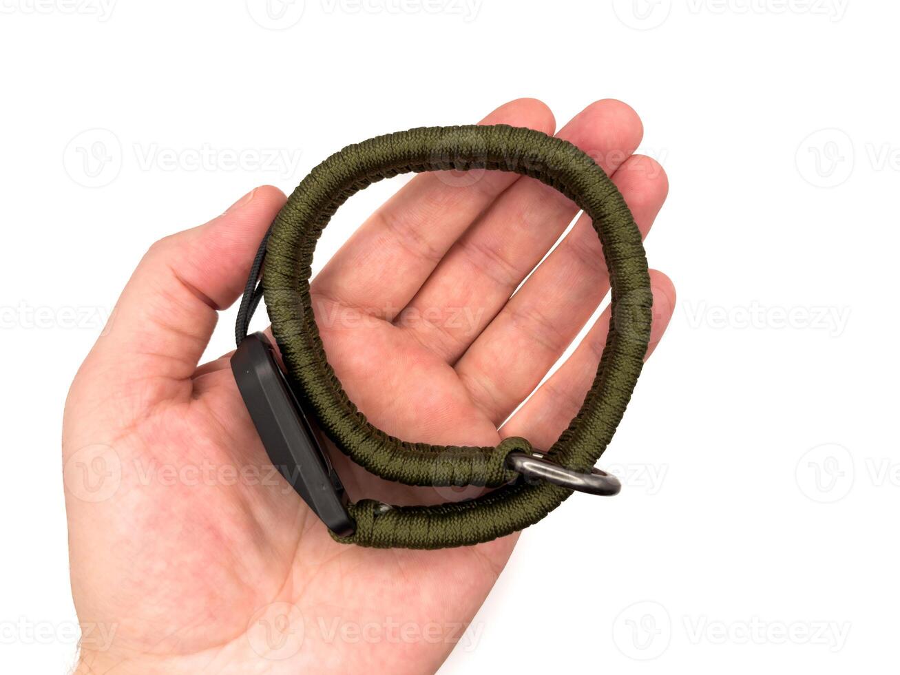 Green camera strap in the form of a rope on a white background. copy, top view, flay lay photo