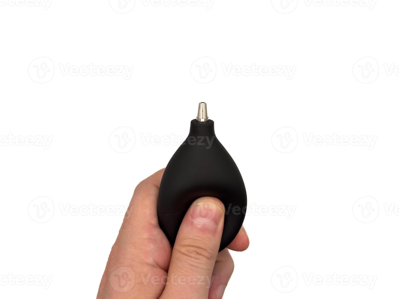 Enema for camera. a black and silver tool is being held by a person, copy space photo