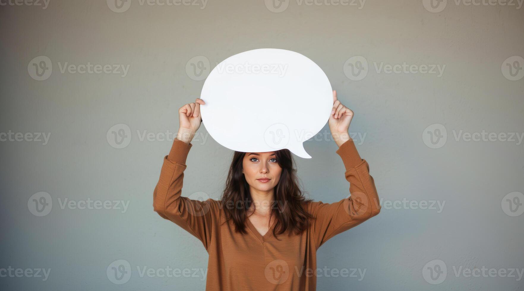 woman holds a white speech bubble over her head. photo