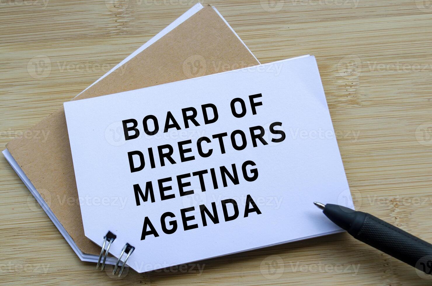 Board Of Directors Agenda on wooden table with pen. photo