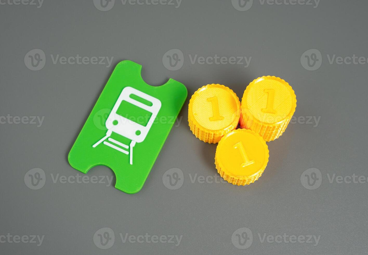 A public transport ticket and a stack of coins. A metro, tram or train ticket. photo
