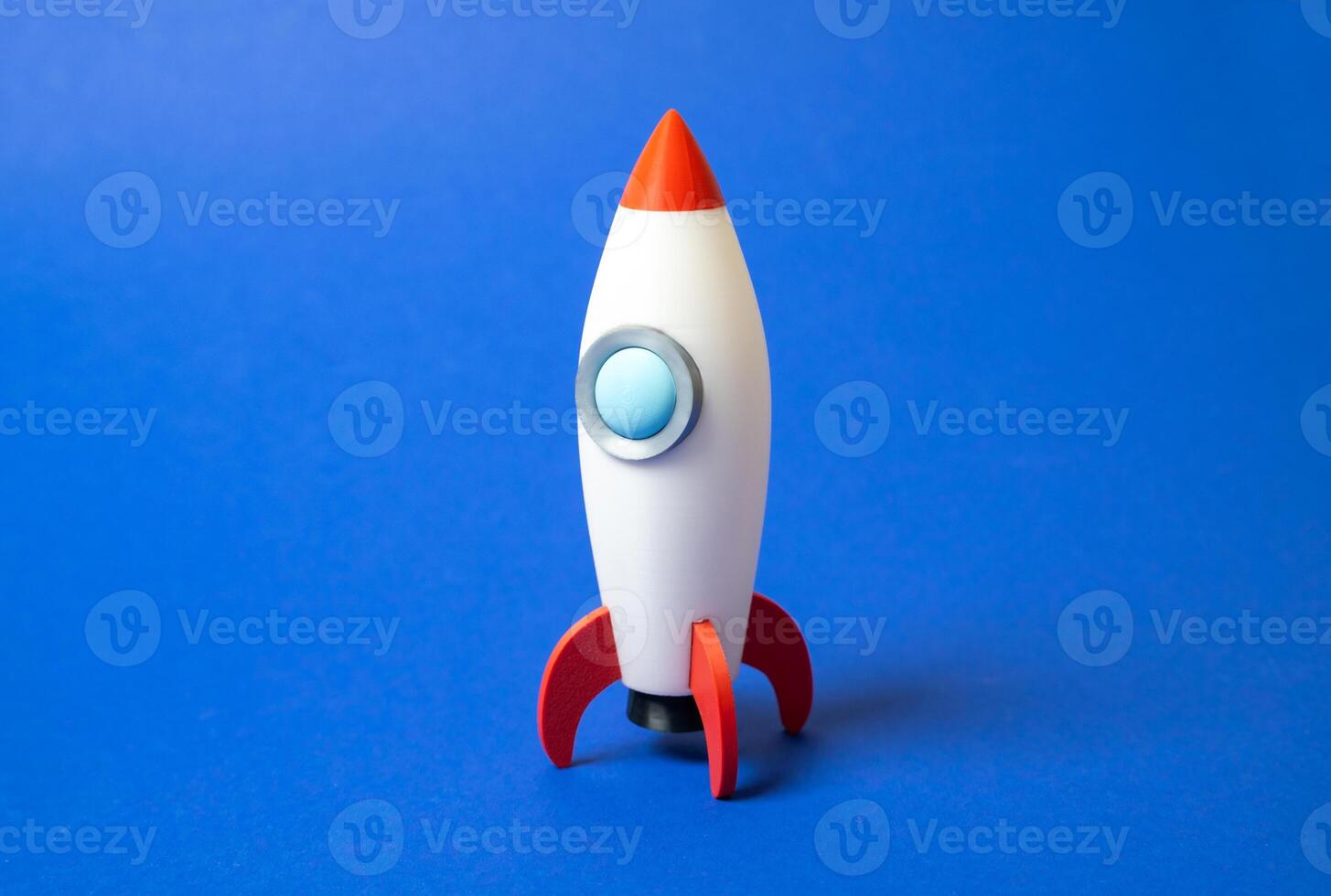 Space rocket on blue background. Concept of space aerotechnics. Advertising, startups. Advanced engineering, scientific progress, or marketing for aerospace. Tech innovation photo