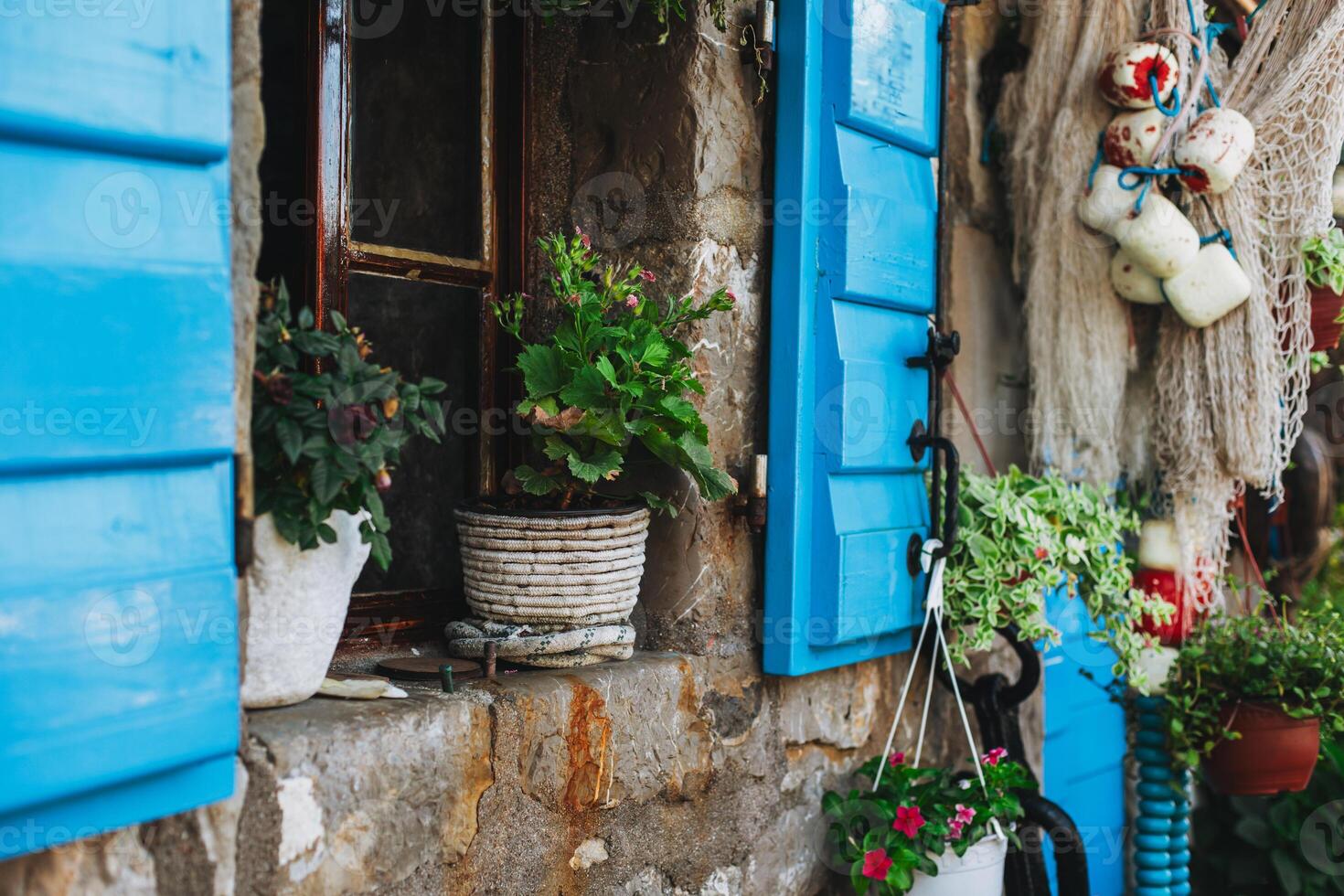 Close up of beautiful old window with flowers in a pots in old town Przno, Montenegro. photo