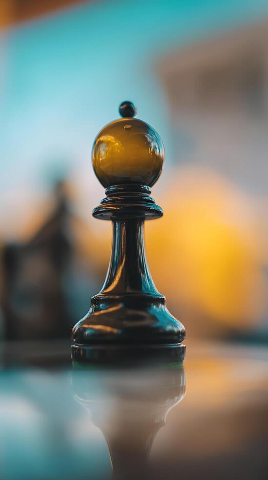 Close Up of a Black Chess Bishop Piece Against a Blurred Background. photo