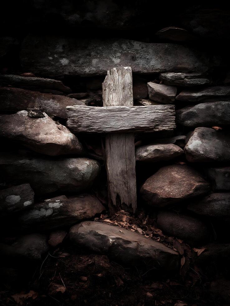 Weathered Wooden Cross nestled in a Stone Wall. A dark and moody image perfect for religious or spiritual themes. photo