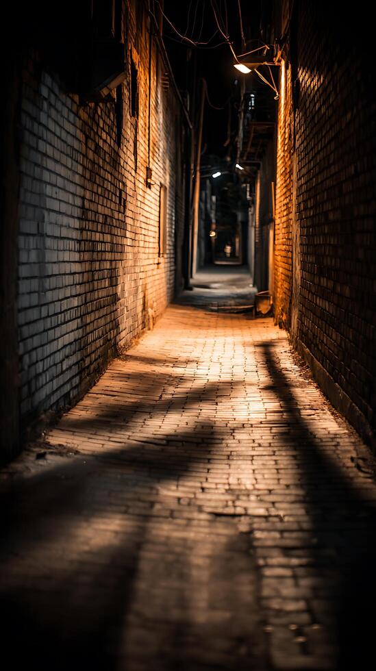 Illuminated Brick Alleyway at Night A Dark and Mysterious Urban Scene. photo