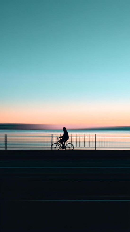 Silhouette of Cyclist at Sunset, Motion Blur Seascape. photo