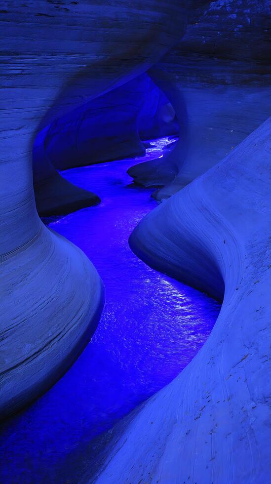 Abstract Blue Canyon A Serpentine Stream Flows Through a Carved Sandstone Passage. photo