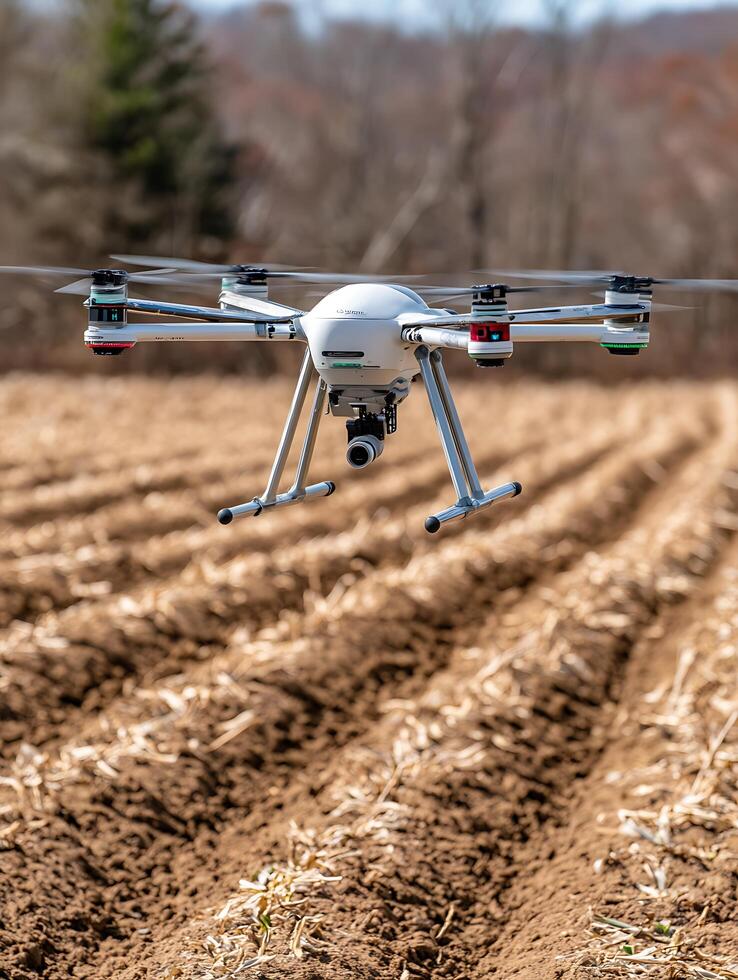Aerial Photography Drone Flying Over Farmland. A close up image of a drone in flight above freshly plowed fields. photo