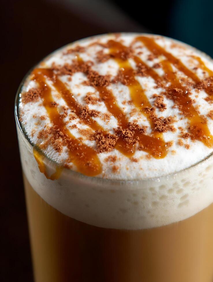 Close up of a Caramel Latte with Cinnamon Topping. A delicious coffee drink perfect for a cozy autumn day. photo