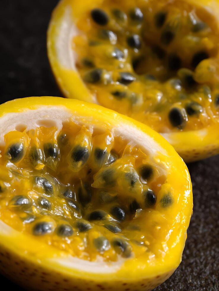 Close up of Two Halved Yellow Passion Fruits, Revealing Juicy Pulp and Seeds. photo