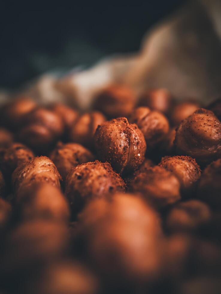 Close Up of Hazelnuts Coated in a Spicy Dust. A Detailed Macro Photograph of Roasted Hazelnuts. photo