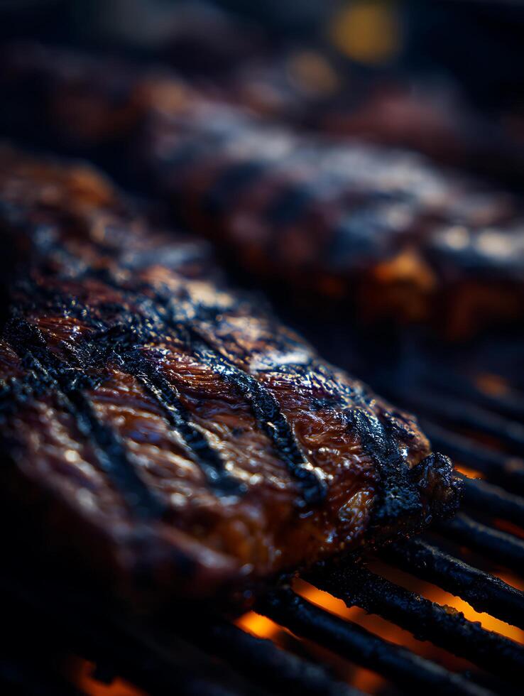 Close Up of Grilled Steaks on a Hot Grill. Juicy and charred meat cooking over an open flame. photo