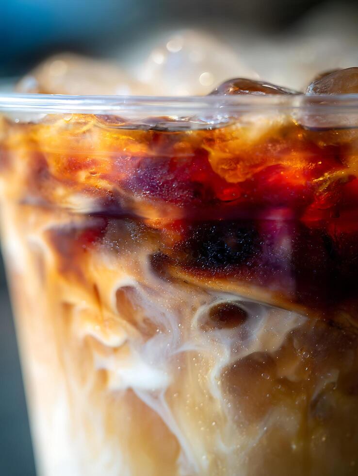 Close Up of Iced Coffee with Cream Swirls and Ice Cubes. A Detailed Macro Photograph of a Refreshing Beverage. photo