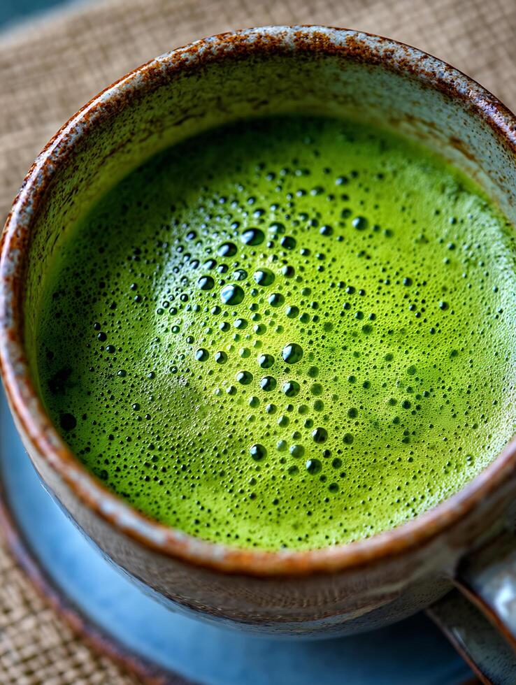 Close up of Frothy Matcha Green Tea in a Rustic Mug. photo