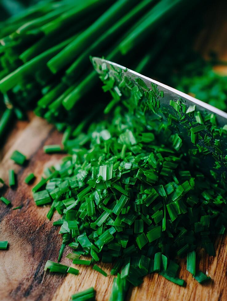Close Up of Freshly Chopped Chives on a Wooden Cutting Board. photo
