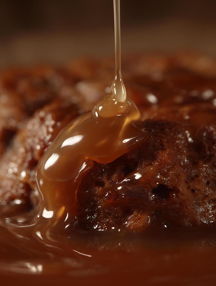 Caramel Sauce Drizzling over Delicious Chocolate Pudding Close Up. photo