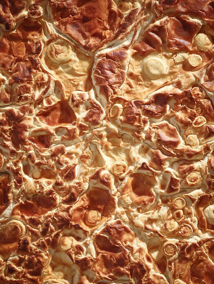 Close Up of Baked Pastry with Golden Brown Texture and Airy Puffs. A Detailed Image Showing the Rich Color and Texture of a Delicious Dessert. photo