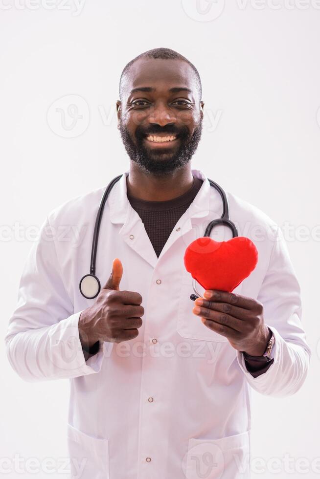 African American male doctor with a red heart pillow, symbolizing dedication to cardiovascular care and healthy lifestyles. photo
