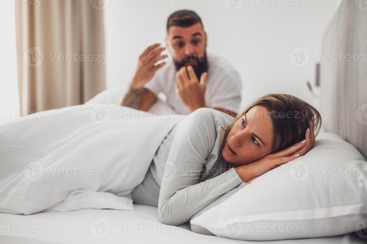 The couple deals with feelings of adultery and mistrust, with visible frustration and sadness in a private setting. photo