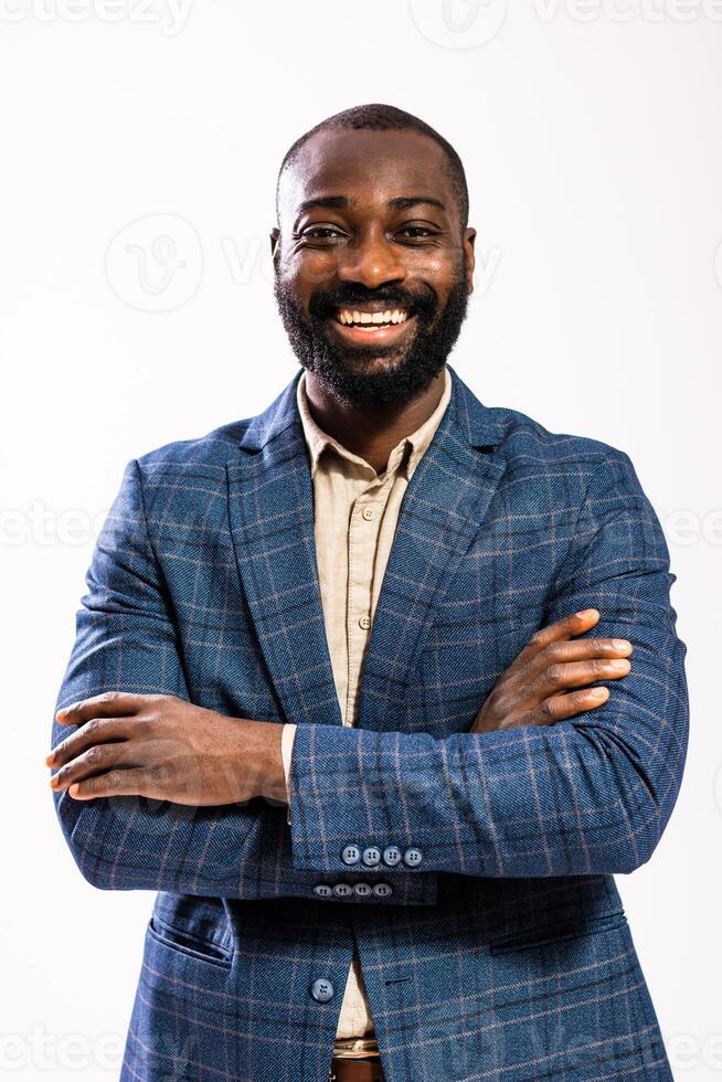Bearded African American man dressed in formal attire laughs joyfully, showcasing professional confidence and happiness in a studio portrait. photo