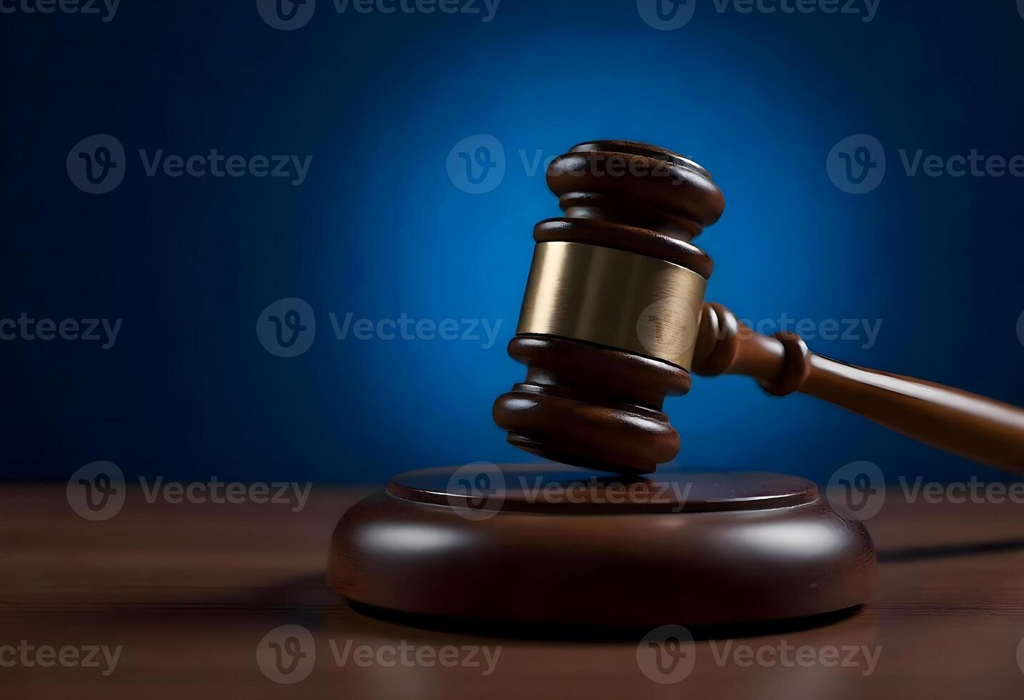 Judge gavel on wooden table with blue background photo