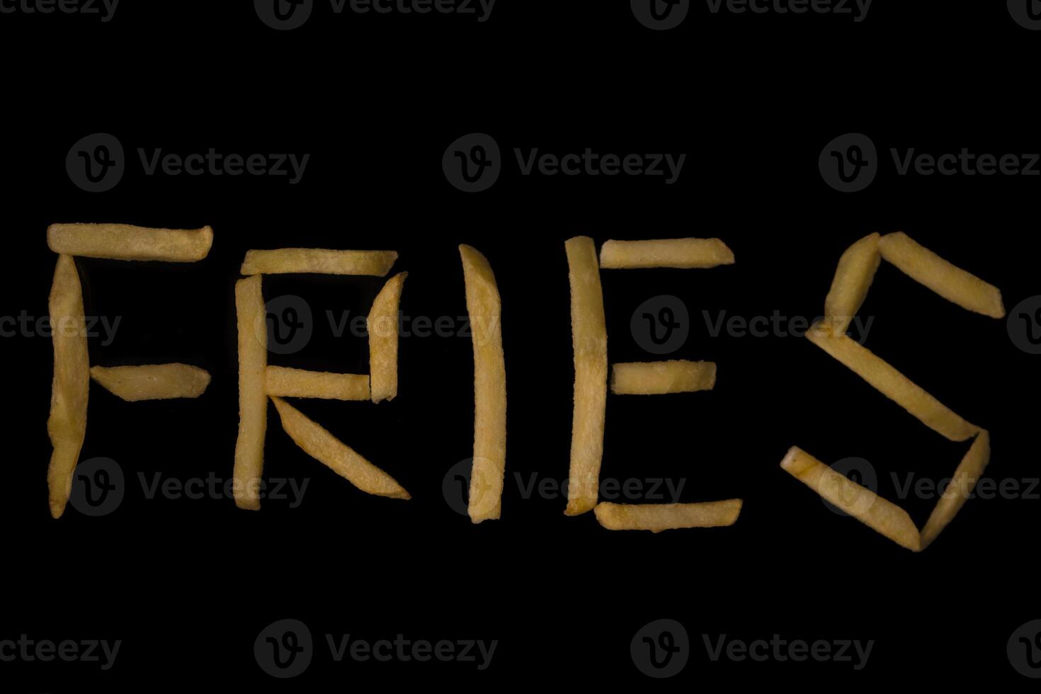 Golden crispy french fries creatively arranged to spell the word FRIES against a dark background, symbolizing popular fast food and delicious snack culture photo