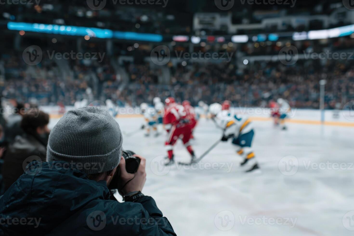 Fan takes picture of Hockey Game at arena photo