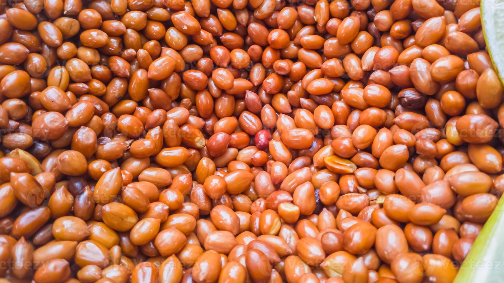 Close-up of a plentiful pile of roasted peanuts photo